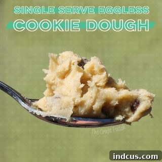 Close-up of a small bowl of edible cookie dough with chocolate chips, ready to be enjoyed.