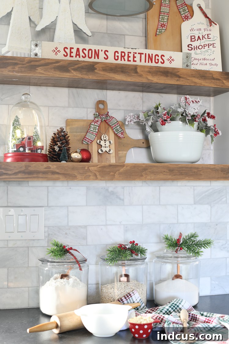 Charming Christmas kitchen decor ideas, featuring festive signs and decorated open shelves.