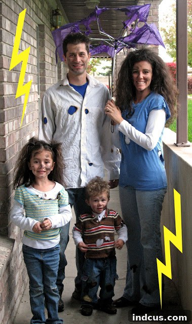 Unique 'Struck by Lightning' family Halloween costume with singed clothes and wild hair.