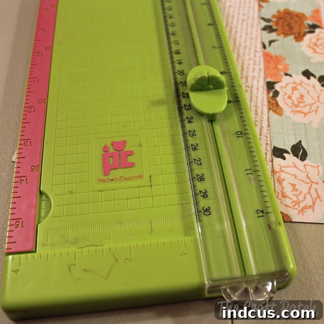 Close-up of a scrapbook paper being scored with a scoring blade