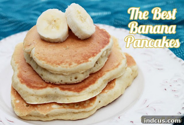 Close-up of golden banana pancake stack with syrup