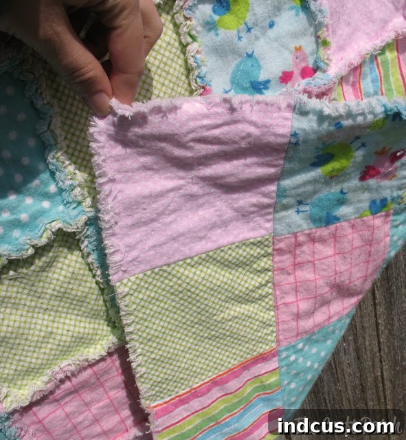 Assortment of neatly cut fabric squares ready for a rag quilt project.