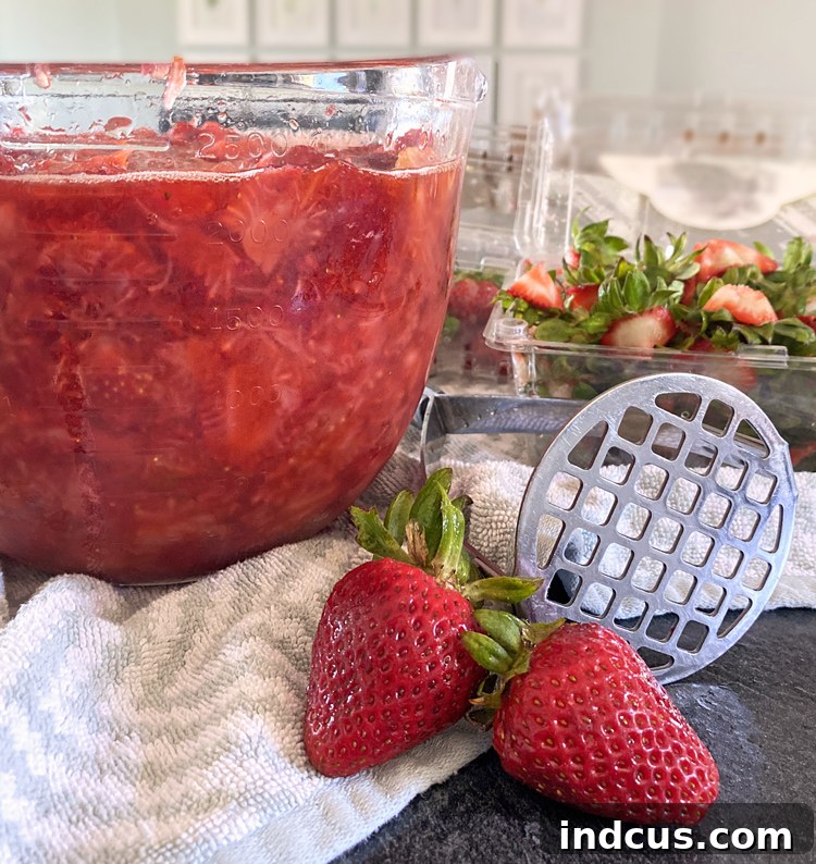 Making jam from fresh strawberries - showing crushed strawberries in a pot