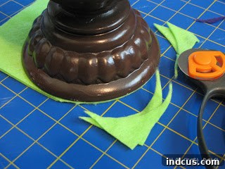 Trace a round object to create a shingle scale shape on felt