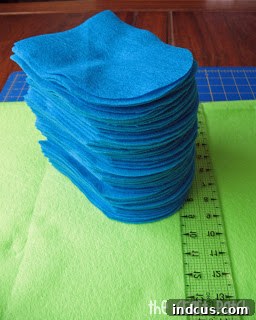 Stack of colorful felt quilt pieces ready for assembly
