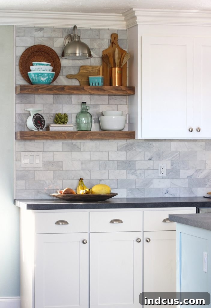 White Kitchen with floating shelves and marble backsplash