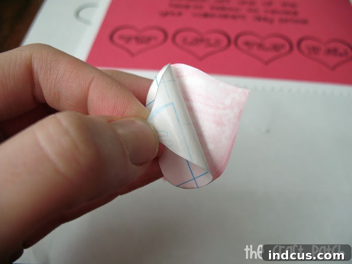 applying homemade scratch off stickers to card