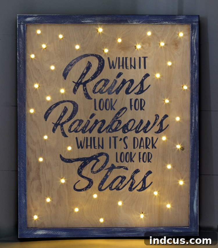 A beautiful wooden sign with the quote 'When it's Dark Look for Stars' illuminated by twinkling LED lights, a perfect example of personalized home decor.