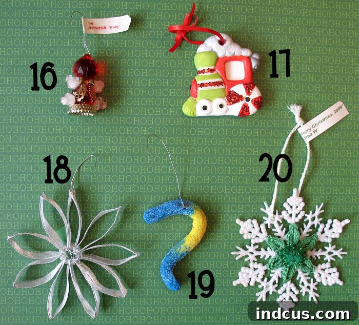 A charming collection of handmade Christmas ornaments, including a model magic snowman, felt poinsettia, a child-made wreath, and a clever candy cane mouse.
