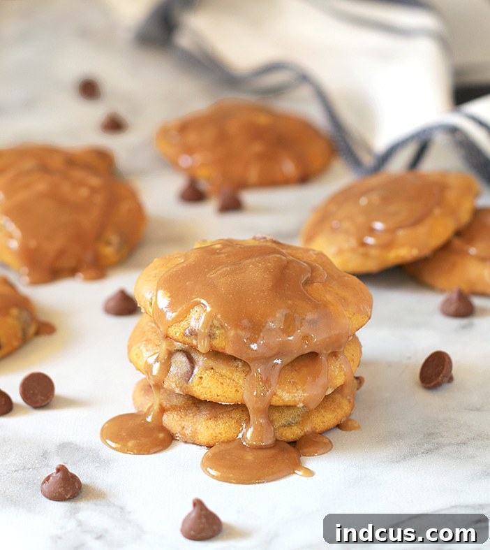 Close-up of a pumpkin chocolate chip cookie with a textured caramel glaze, showcasing the perfect autumnal dessert.