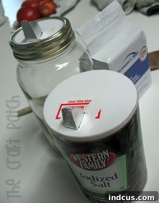 Canning jar with DIY pour spout in action, dispensing yeast into a measuring spoon.