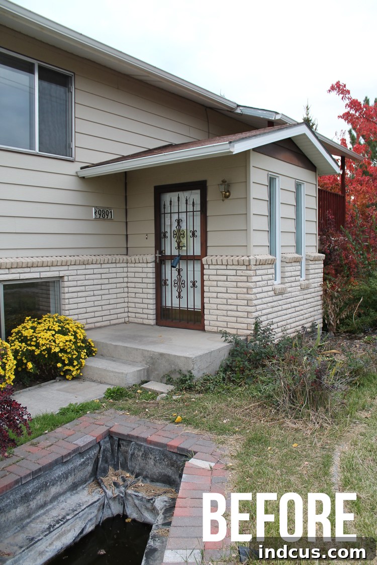 The Clarity Project 2 Before renovation: A sad, dated 80s split-entry home with brown door and overgrown landscaping