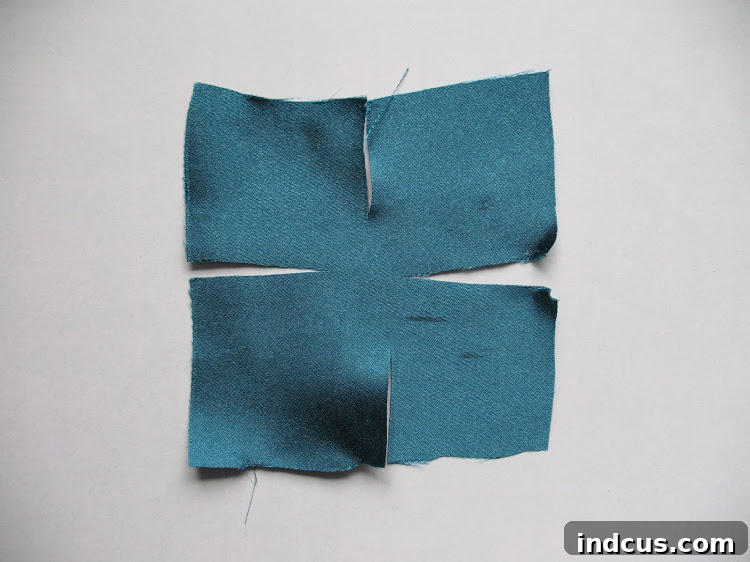 Stunning Satin Flowers DIY 5 Detailed image showing how to cut slits in satin fabric squares for petals