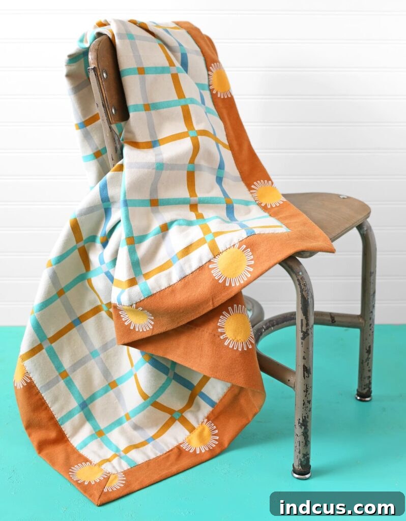 A beautifully finished flannel baby blanket with a mitered border, ready for use.