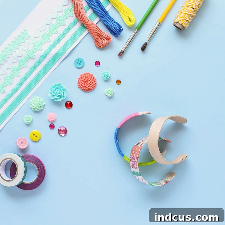 A collection of beautifully decorated popsicle stick bracelets with various embellishments including paint, glitter, and thread.