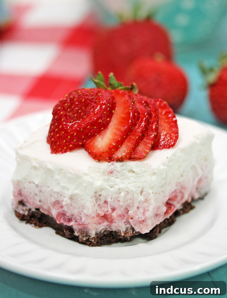 Beautifully presented Strawberry Cloud Dessert with fresh strawberries on top