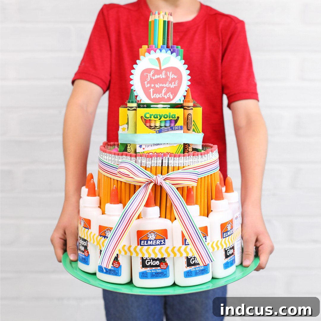 Vibrant multi-tiered school supply cake for teacher appreciation