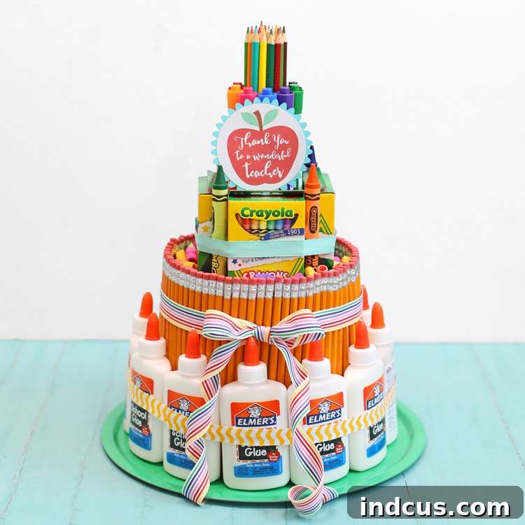 Close-up of a DIY school supply cake featuring a variety of stationery
