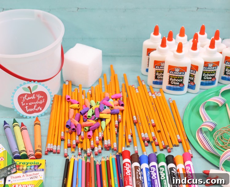 Materials laid out for making a teacher appreciation school supply cake