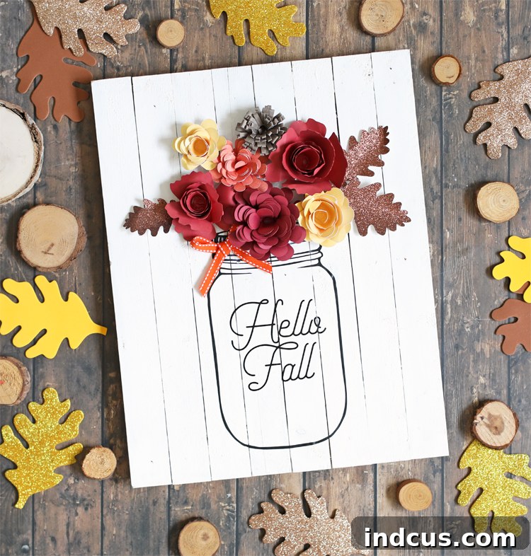 Assembling rolled paper flowers and leaves onto the Hello Fall sign