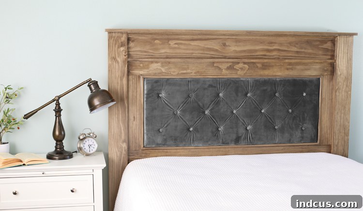 Close-up of the elegant wood and tufted velvet headboard