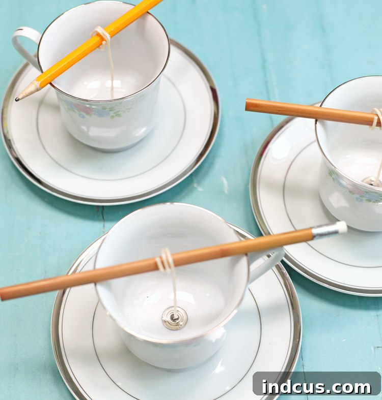 Securing candle wick in a teacup.