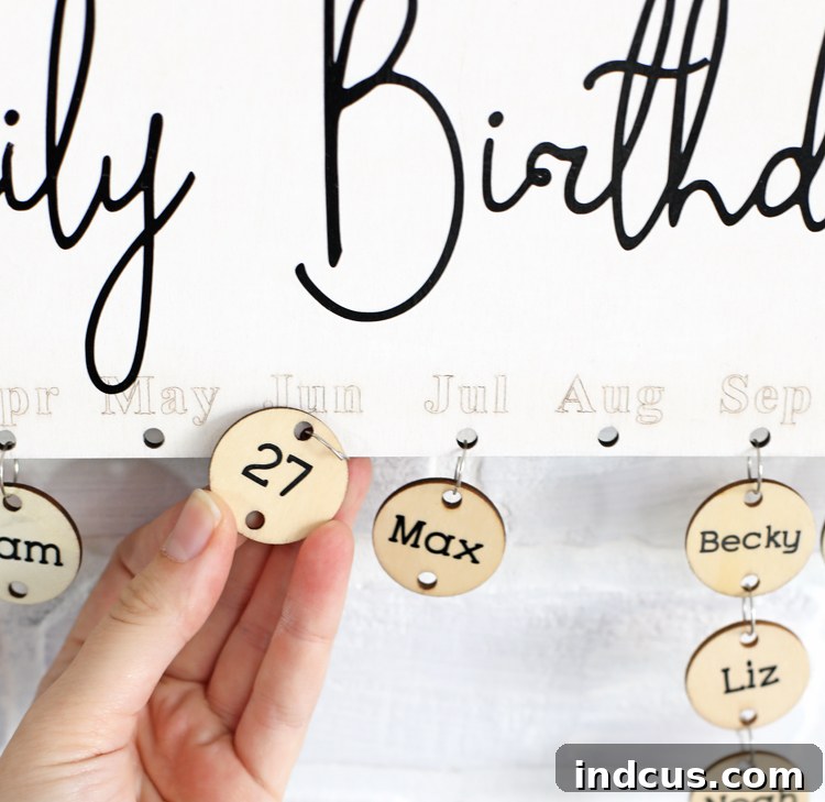 attaching personalized wooden circles to the birthday board