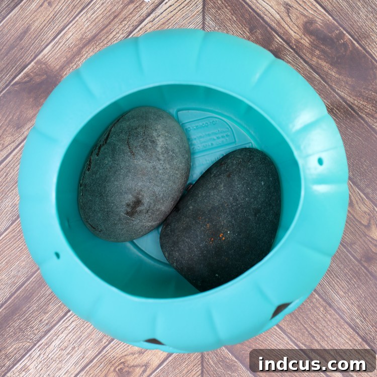 Adding heavy rocks to the base of a plastic pumpkin bucket for stability