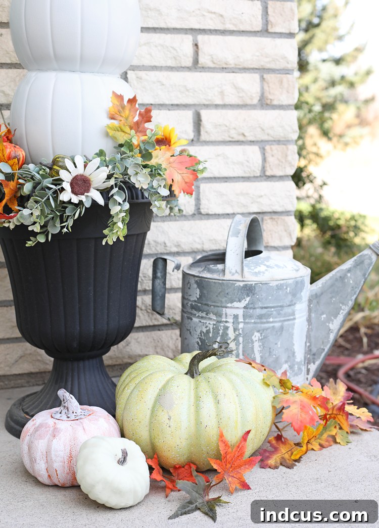 Elegant fall porch setup with DIY white pumpkin topiaries in decorative urns