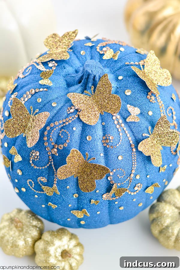 Glitter painted Cinderella pumpkin with butterflies
