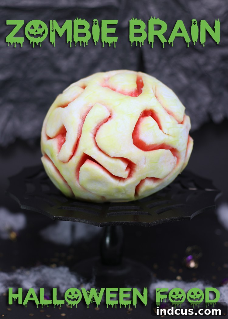 A Pinterest-friendly image displaying the finished edible watermelon zombie brain with the text 'Pin it so you don't forget it!', encouraging sharing and saving of the recipe.