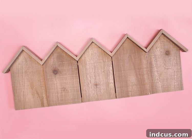 Close-up of a rustic birdhouse wood panel, the base for the miniature Christmas houses, hinting at creative possibilities.
