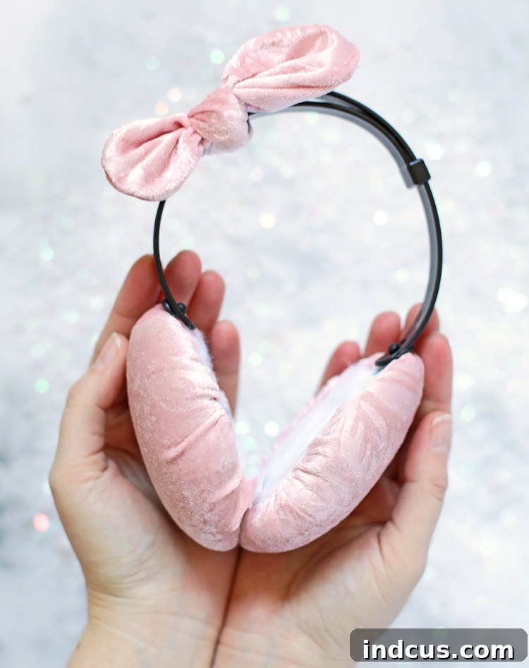Completed custom ear muffs featuring a decorative fabric bow on the headband