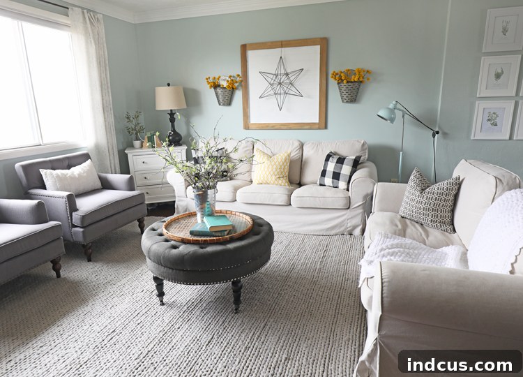 Transformed living room with navy blue velvet sofas and colorful decor