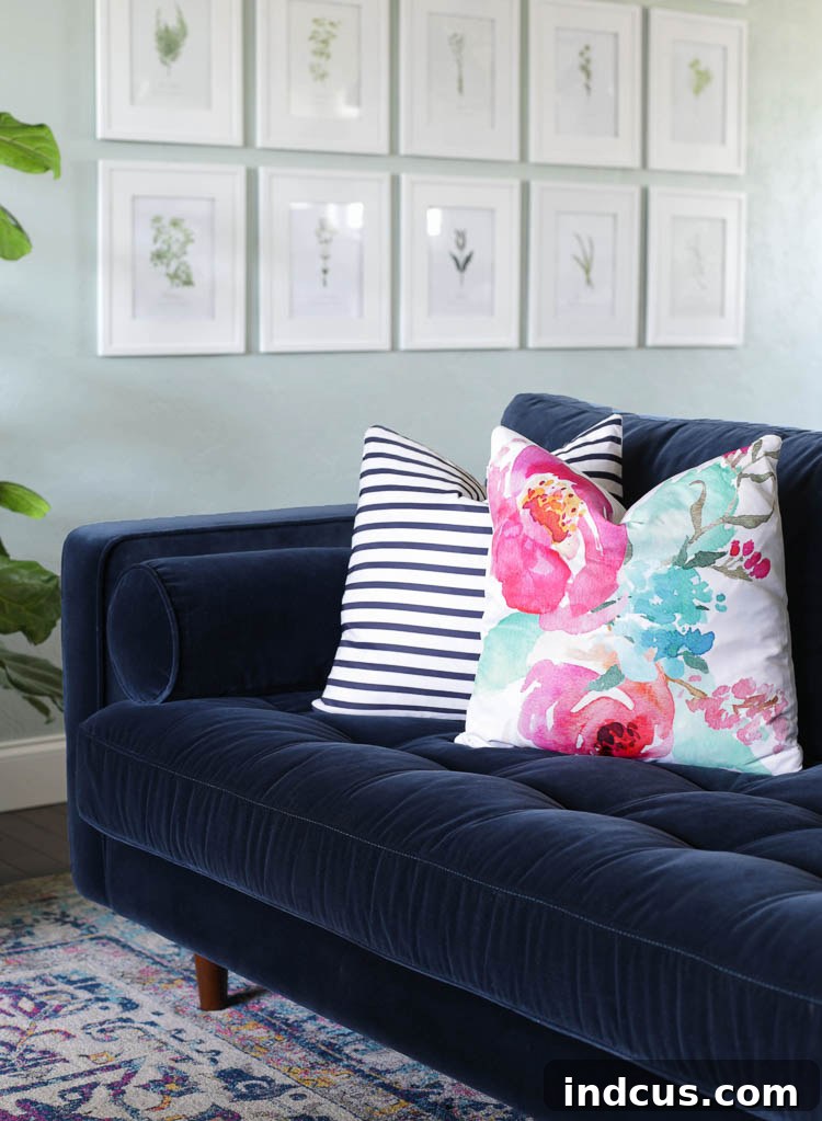 Colorful throw pillows on the navy blue sofa, matching the vintage-style rug