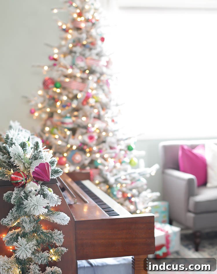 Pink and colorful Christmas decorations on a flocked garland