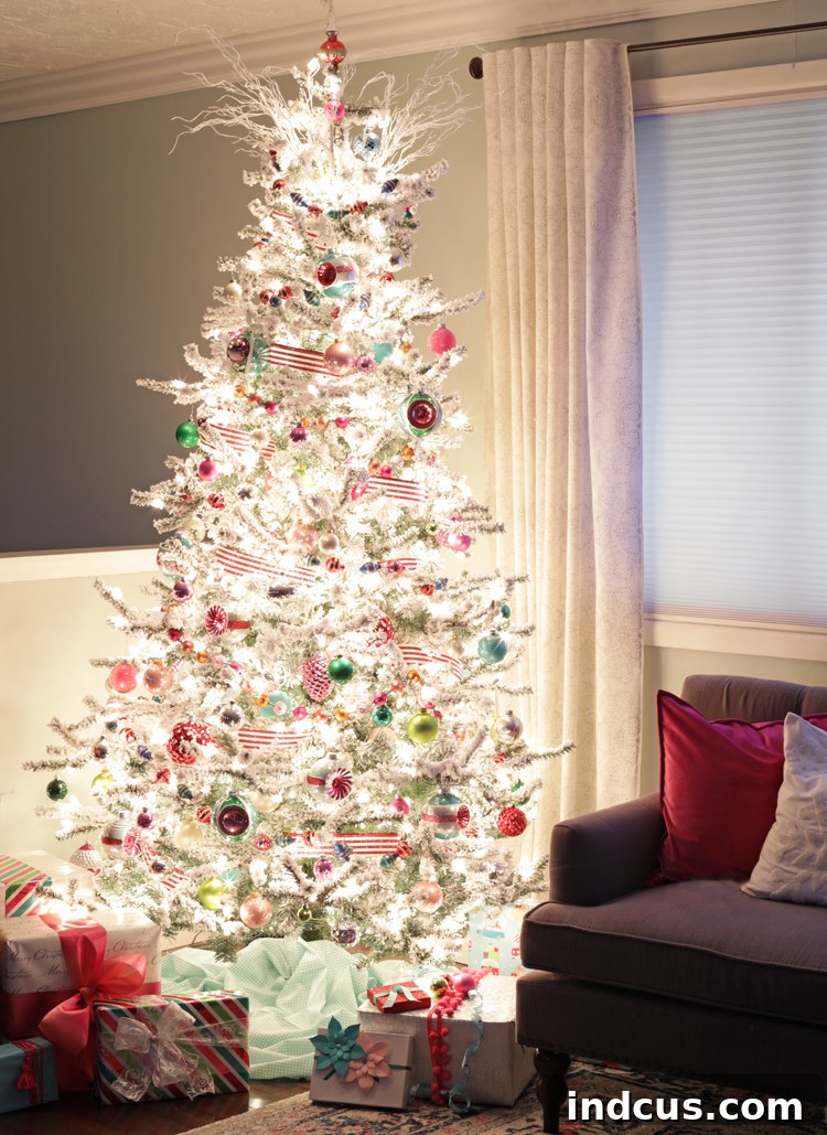 Flocked Christmas tree illuminated at night with warm lights