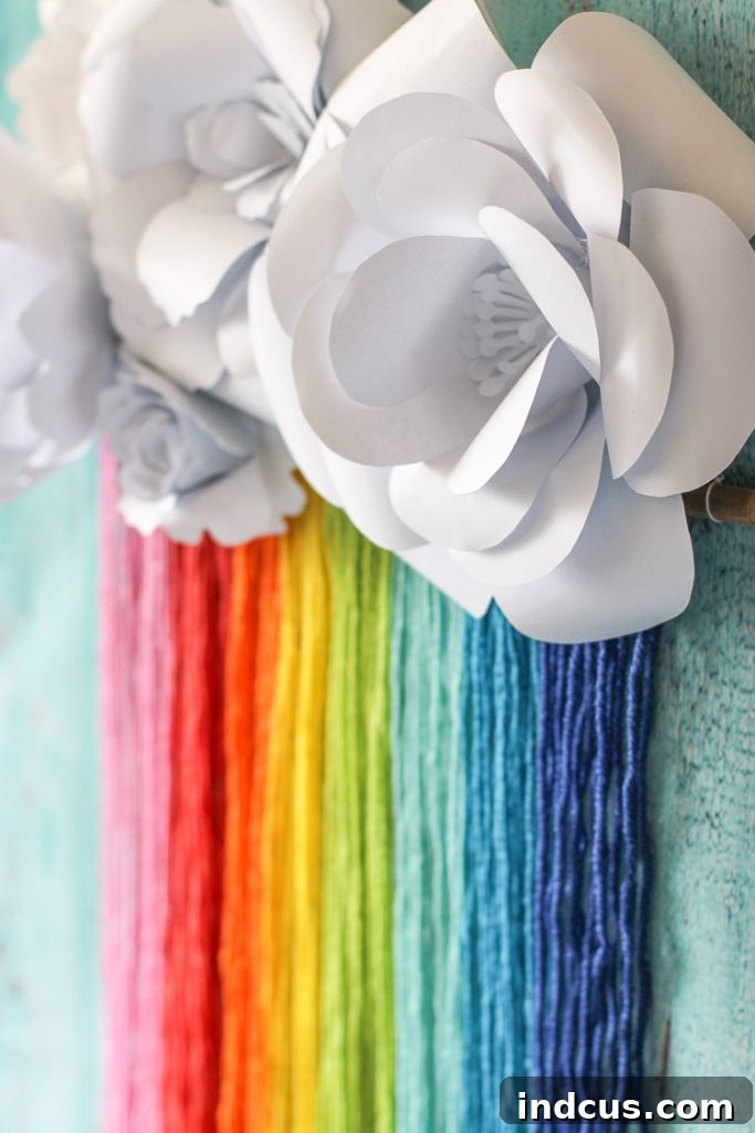 DIY this cute rainbow macrame and paper flower craft, a joyful addition that combines textile art with delicate paper embellishments.