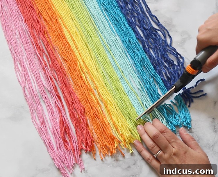 Trimming the ends of the string is the last step in shaping your macrame wall hanging, allowing for custom designs and a polished finish.