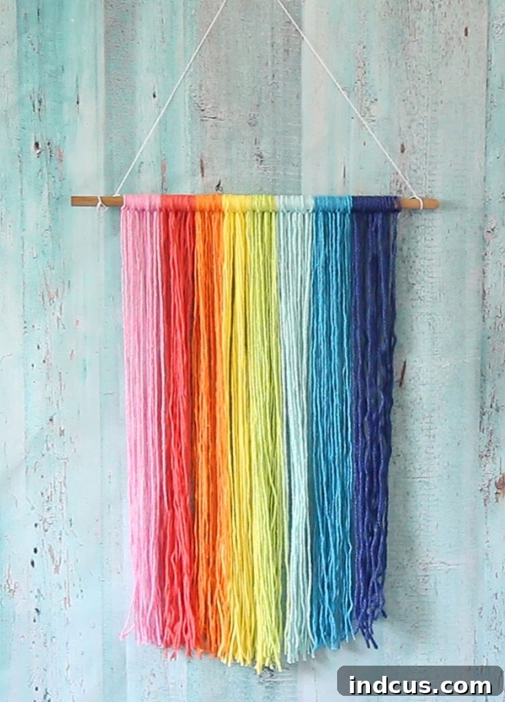 Easy rainbow craft wall hanging, showcasing the completed yarn macrame before adding any additional embellishments.