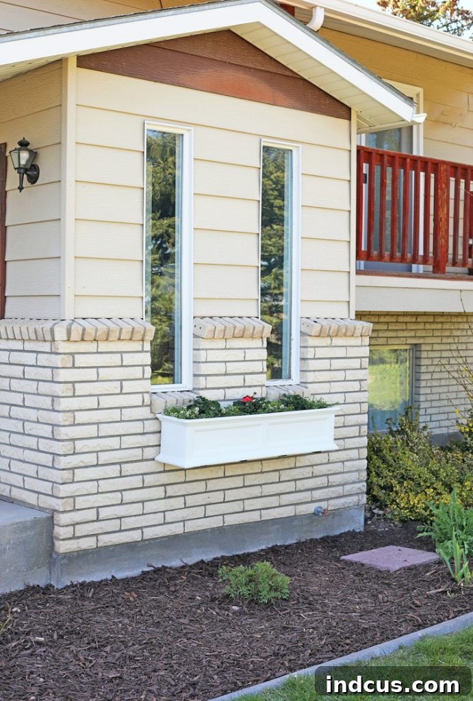 Beautiful window box filled with vibrant flowers adorning a classic brick house exterior, enhancing curb appeal