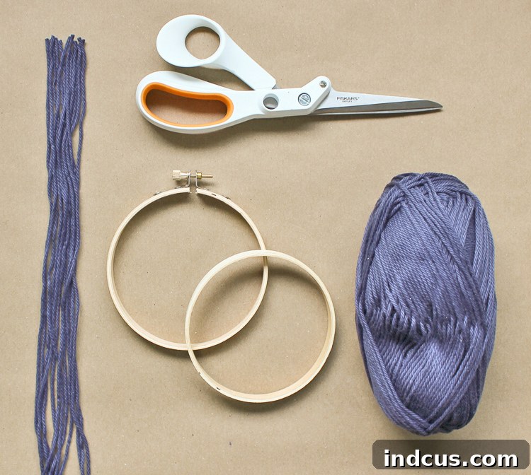 Demonstration of separating inner and outer parts of an embroidery hoop for crafting purposes