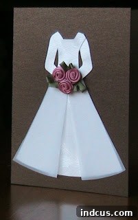 Handmade wedding card featuring a brown dress with a pink bouquet on shimmery paper