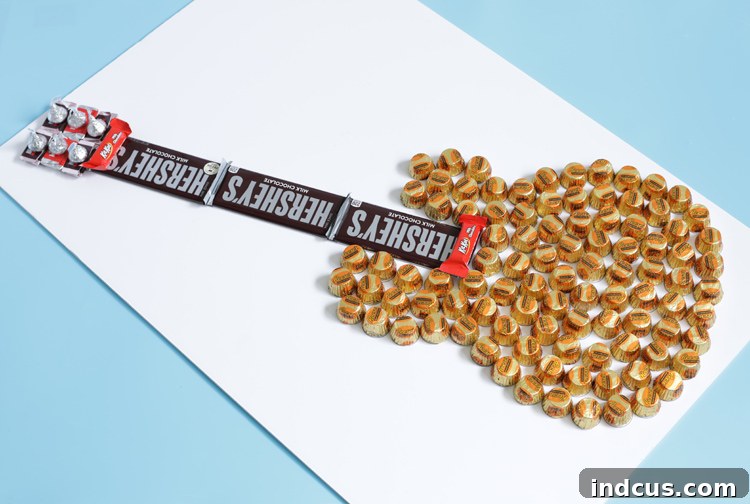 Detailed shot of the candy bar guitar neck and headstock with Hershey's bars and Kisses glued on