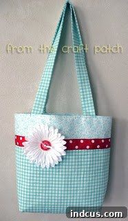 Smile Satchel 3 Another perspective of the finished handmade bag, highlighting its sturdy structure, elegant design, and the beautiful contrast of red with the patterned cotton fabric.