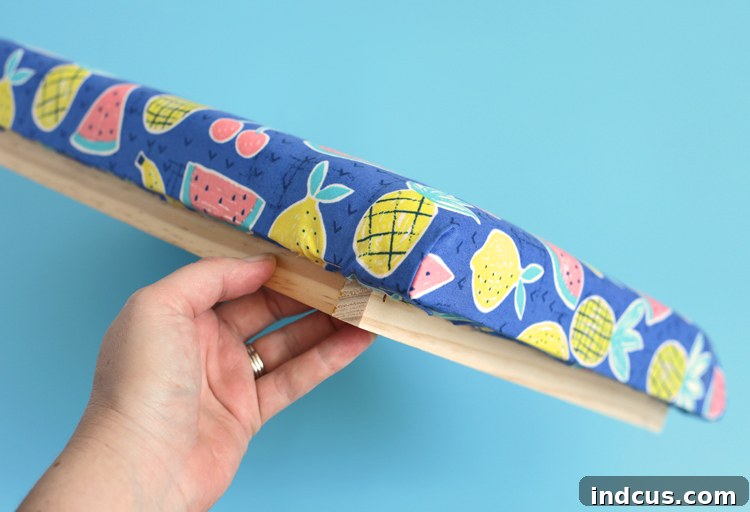 Folding and stapling upholstery fabric corners for a neat finish