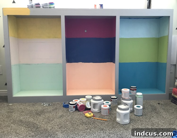 Mismatched vibrant paint colors on a cabinet, revealing a craft project gone wrong