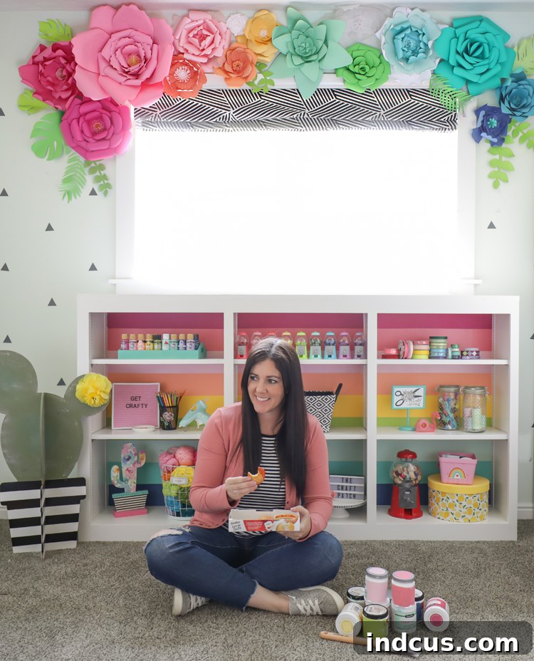 Close-up of the rainbow striped cabinet shelf filled with colorful craft supplies and decor