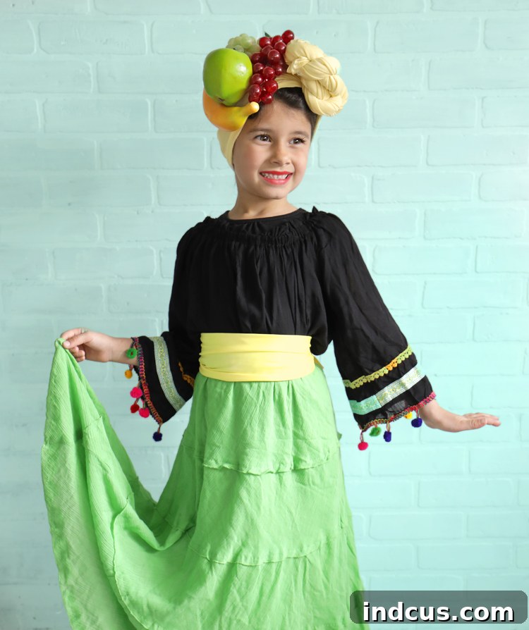 Effortless Carmen Miranda Halloween Look 2 A young girl smiling brightly in her finished Carmen Miranda Halloween costume, featuring a vibrant fruit headpiece, green tiered skirt, and peasant blouse.