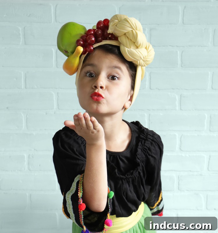 Effortless Carmen Miranda Halloween Look 6 The young girl in her Carmen Miranda costume looking directly at the camera with a big smile, fully embracing her role.